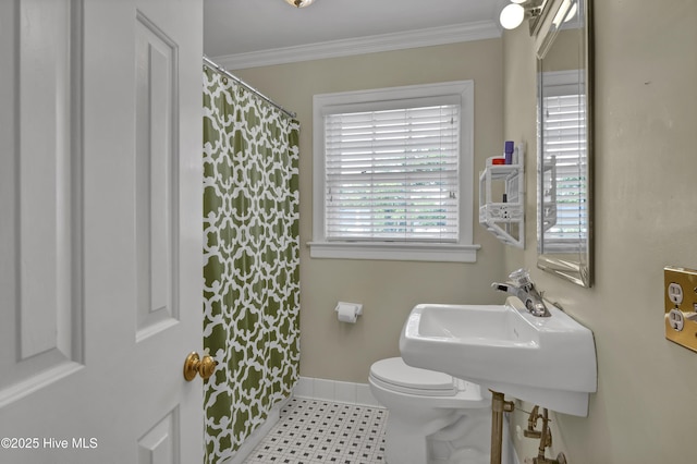 2405 Oleander Dr, Wilmington, NC 28403 - bathroom with crown molding, a sink, curtained shower, baseboards, and toilet