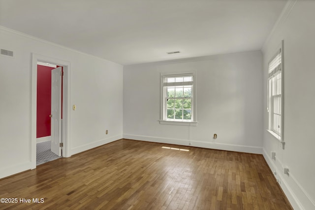 2405 Oleander Dr, Wilmington, NC 28403 - spare room featuring hardwood / wood-style floors, baseboards, visible vents, and crown molding