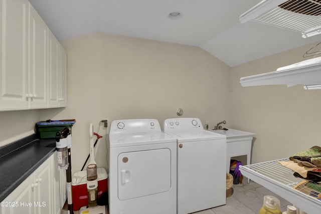 2405 Oleander Dr, Wilmington, NC 28403 - laundry area with washing machine and dryer, light tile patterned flooring, and cabinet space