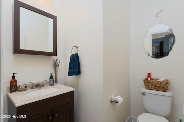 bathroom featuring toilet and vanity
