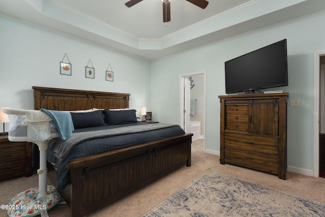 bedroom with ceiling fan, crown molding, a tray ceiling, and light carpet