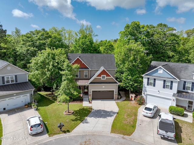 craftsman-style house with concrete driveway, a front lawn, a garage, and roof with shingles