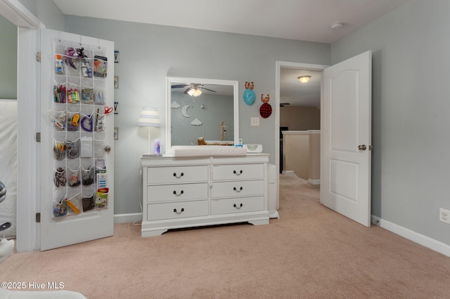 bedroom featuring baseboards and light carpet