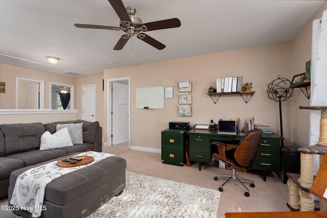 office space with attic access, ceiling fan, light colored carpet, and baseboards