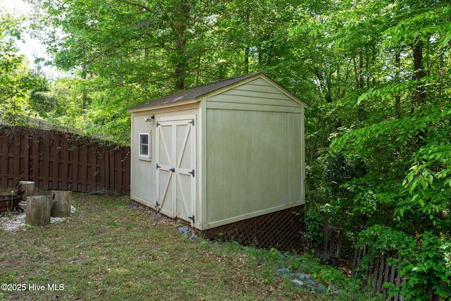 view of shed featuring fence