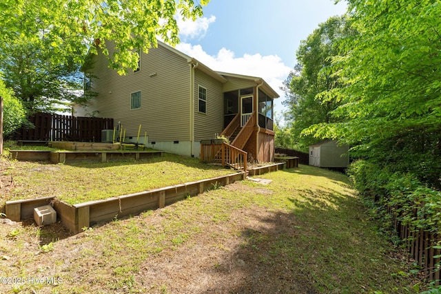 back of house with an outdoor structure, a shed, crawl space, stairway, and a sunroom