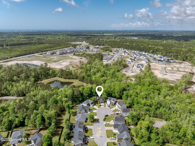 aerial view featuring a wooded view and a residential view