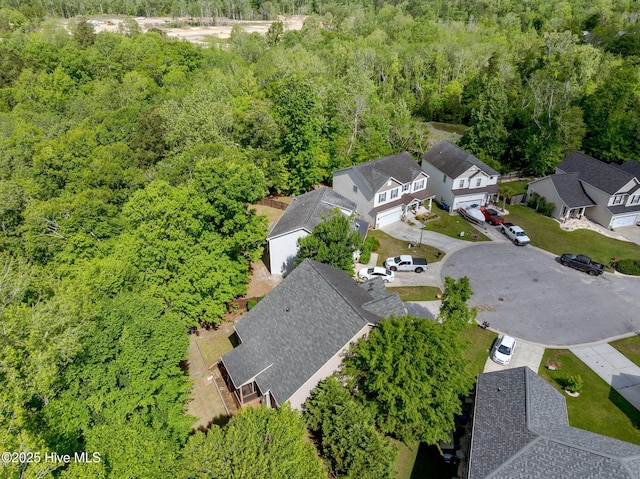 birds eye view of property featuring a residential view and a view of trees