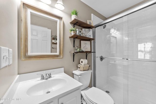 full bath featuring toilet, a shower stall, and vanity