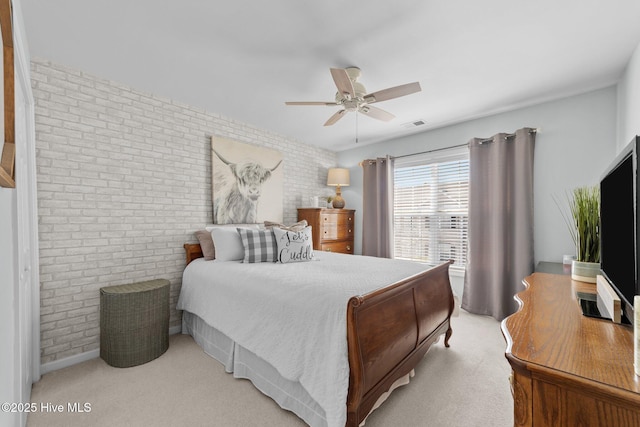 bedroom with visible vents, ceiling fan, brick wall, and light carpet