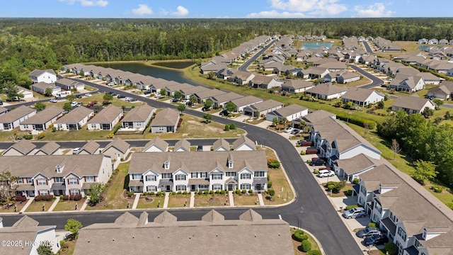 bird's eye view with a water view, a residential view, and a wooded view