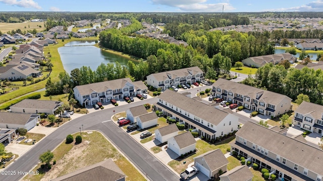 birds eye view of property featuring a water view and a residential view