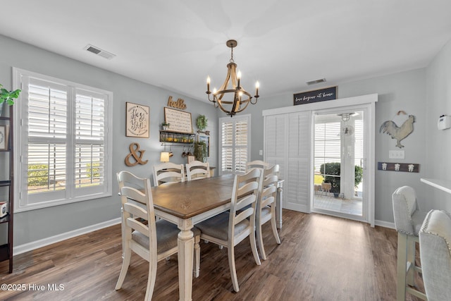dining space featuring a notable chandelier, visible vents, and plenty of natural light