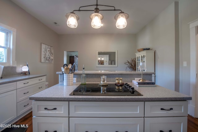 223 N Main St, Wendell, NC 27591 - kitchen with white cabinets, dark wood-style flooring, black electric stovetop, and visible vents