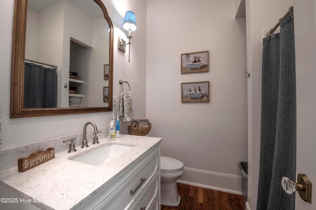 223 N Main St, Wendell, NC 27591 - bathroom featuring toilet, baseboards, wood finished floors, curtained shower, and vanity