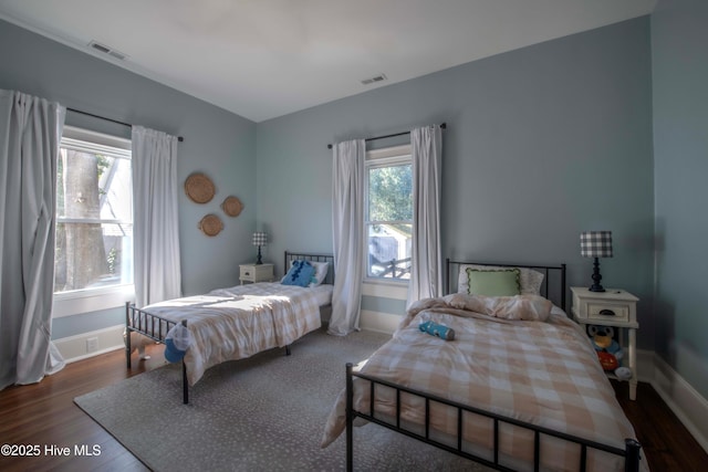 223 N Main St, Wendell, NC 27591 - bedroom with wood finished floors, visible vents, and baseboards
