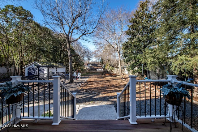 223 N Main St, Wendell, NC 27591 - wooden deck featuring an outdoor structure and a storage unit