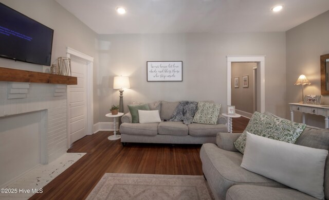 223 N Main St, Wendell, NC 27591 - living room featuring baseboards, wood finished floors, a brick fireplace, and recessed lighting
