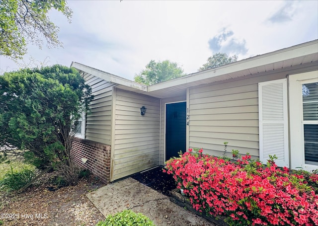 property entrance featuring brick siding