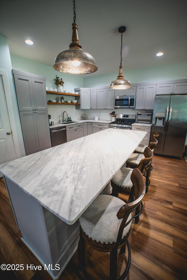 596 W Burton Farm Dr, Minnesott Beach, NC 28510 - kitchen with a sink, stainless steel appliances, open shelves, light stone counters, and gray cabinetry