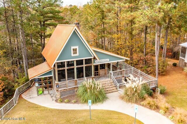 596 W Burton Farm Dr, Minnesott Beach, NC 28510 - rear view of property with covered porch, stairway, and a wooded view