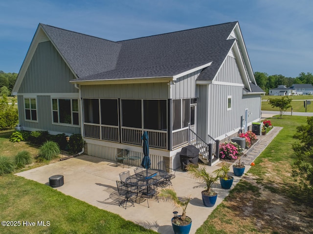 596 W Burton Farm Dr, Minnesott Beach, NC 28510 - rear view of house with roof with shingles, a patio area, a yard, cooling unit, and a sunroom