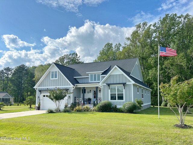 view of front of home featuring board and batten siding, a porch, a front lawn, concrete driveway, and a shingled roof
