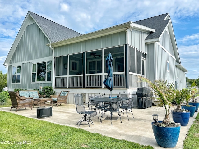 back of house featuring board and batten siding, a ceiling fan, a shingled roof, and outdoor lounge area