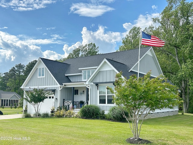 view of front of home featuring a front yard, roof with shingles, board and batten siding, a porch, and driveway