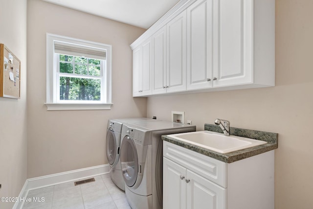 118 Legacy Oaks Dr, Wallace, NC 28466 - laundry room featuring cabinet space, washer and clothes dryer, baseboards, and light tile patterned flooring