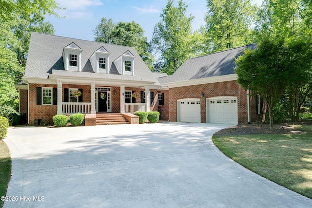 118 Legacy Oaks Dr, Wallace, NC 28466 - cape cod home with covered porch, an attached garage, driveway, and brick siding