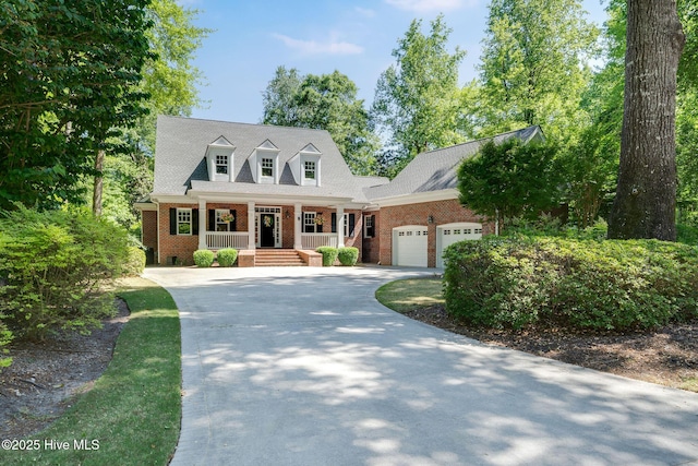 118 Legacy Oaks Dr, Wallace, NC 28466 - cape cod house featuring a porch, an attached garage, brick siding, and concrete driveway