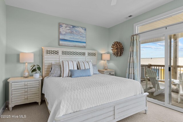 carpeted bedroom with access to outside and baseboards