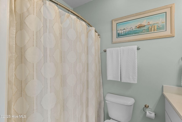 full bath featuring vanity and toilet