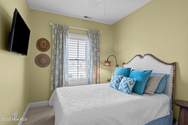 carpeted bedroom featuring baseboards