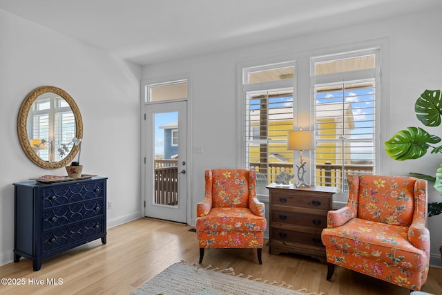 living area with wood finished floors and baseboards
