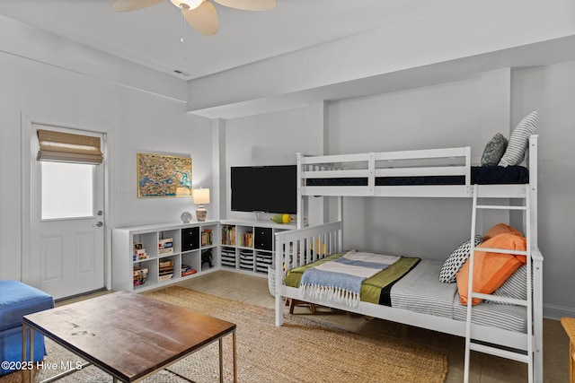 tiled bedroom featuring a ceiling fan