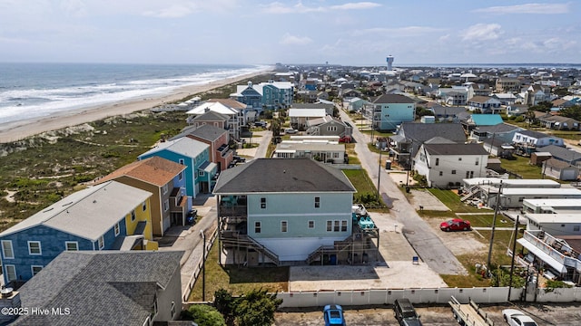 aerial perspective of suburban area featuring waterfront with a beach