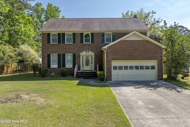 colonial-style house with fence, a front yard, brick siding, an attached garage, and driveway