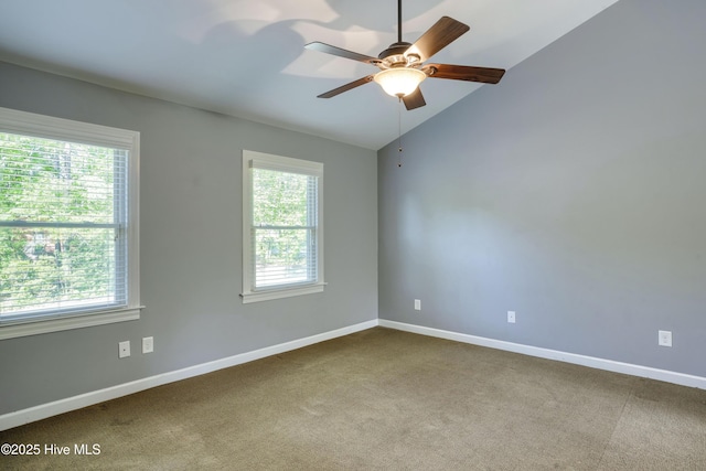 spare room featuring ceiling fan, vaulted ceiling, and plenty of natural light