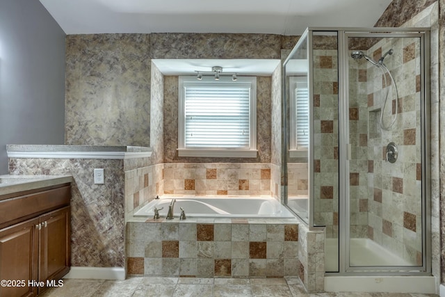 bathroom with vanity, a stall shower, and a garden tub