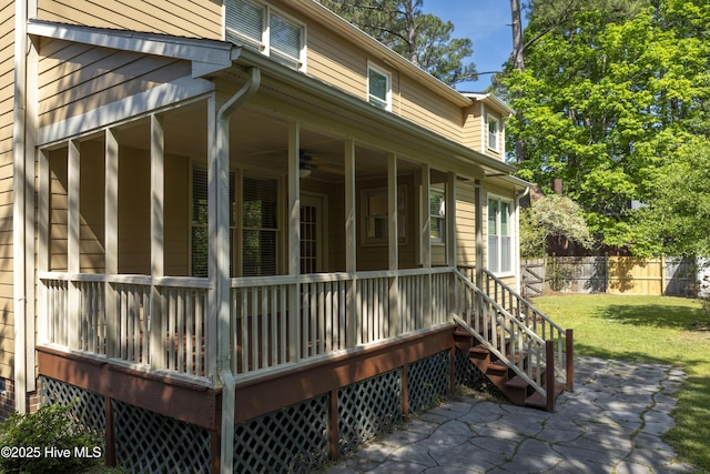 view of home's exterior with fence, a yard, and a patio area