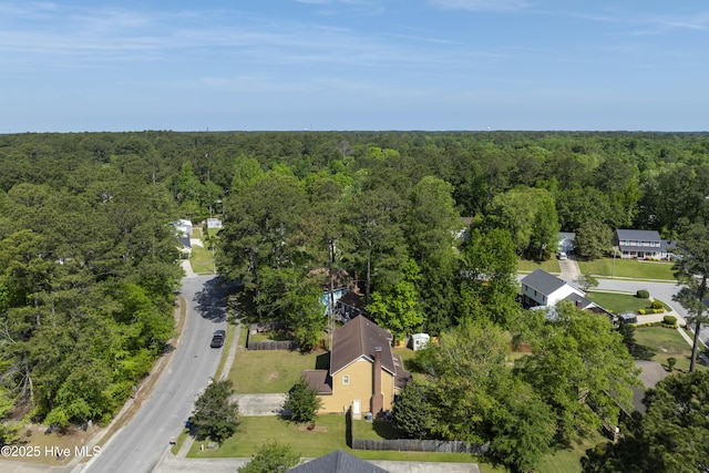 birds eye view of property with a forest view