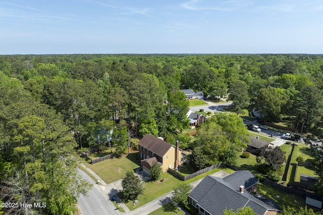 drone / aerial view featuring a wooded view