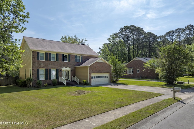colonial home featuring brick siding, a garage, a front yard, and concrete driveway