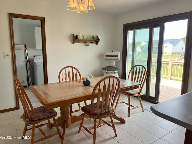 214 Channel View Ct, Cape Carteret, NC 28584 - dining space with washer / dryer, a chandelier, and light tile patterned flooring