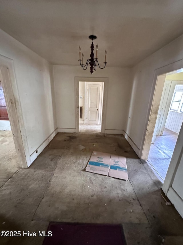 300 W Bryant St, Enfield, NC 27823 - unfurnished dining area with baseboards and an inviting chandelier
