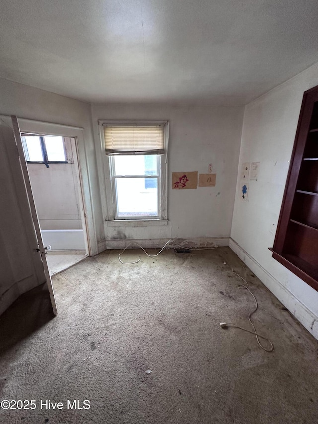 300 W Bryant St, Enfield, NC 27823 - spare room featuring carpet floors and a healthy amount of sunlight