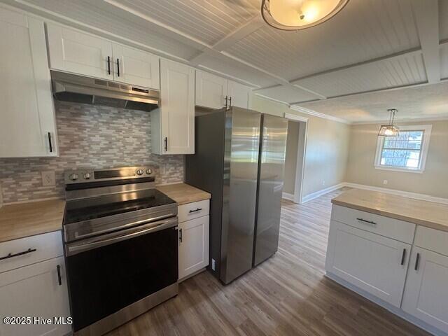 kitchen featuring wood finished floors, under cabinet range hood, white cabinetry, and appliances with stainless steel finishes