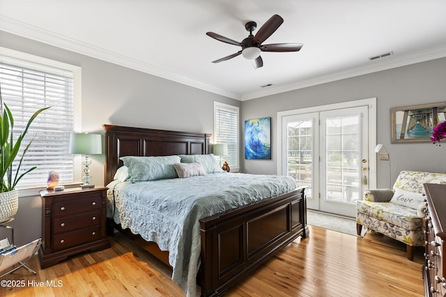 bedroom with visible vents, light wood-style floors, multiple windows, and access to exterior
